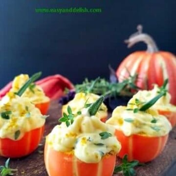 a bunch of pumpkin deviled eggs in a platter