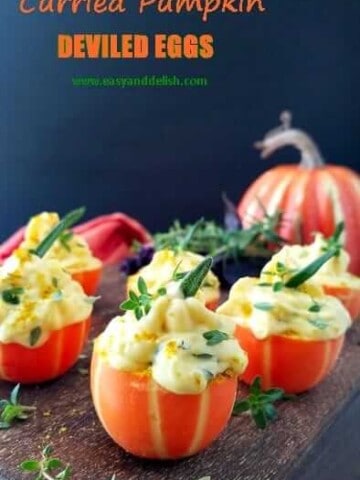 a bunch of pumpkin deviled eggs in a platter