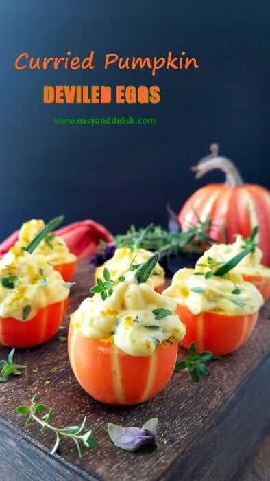 a bunch of pumpkin deviled eggs in a platter