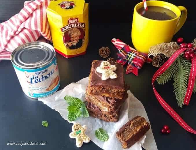 A pile of gingerbread cookie bars served with hot chocolate