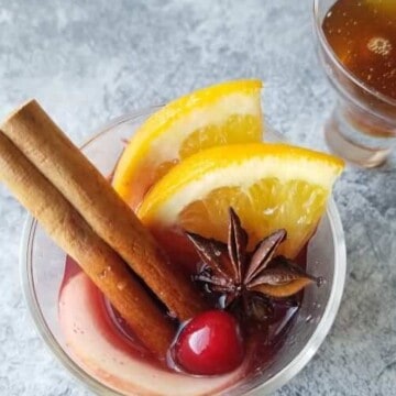 A glass of christmas mulled wine garnished for the holidays