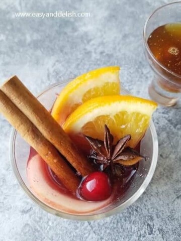 A glass of christmas mulled wine garnished for the holidays
