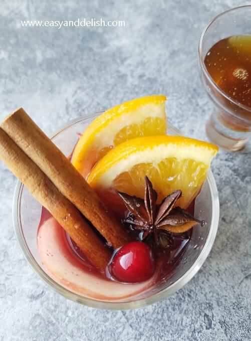 A glass of mulled wine garnished for the holidays