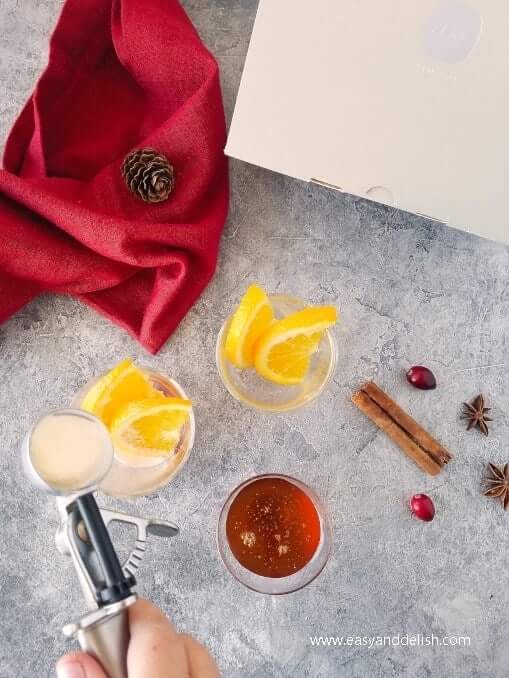 Ice cream being place in a glass that will serve snowball mulled wine