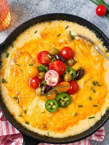Cheesy cod topped with cherry tomatoes, olives, jalapeño, and chopped chives.
