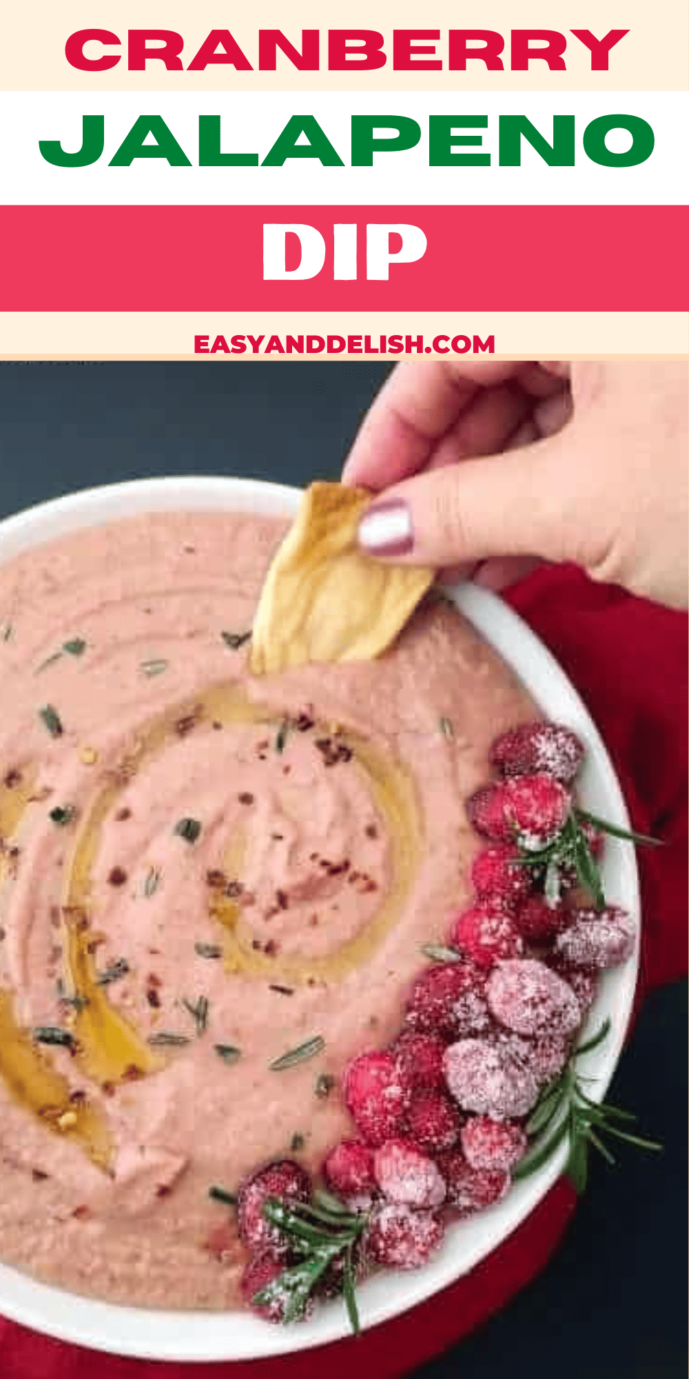 Pin showing a bowl of cranberry jalapeno dip with a pita chip dipped in. 