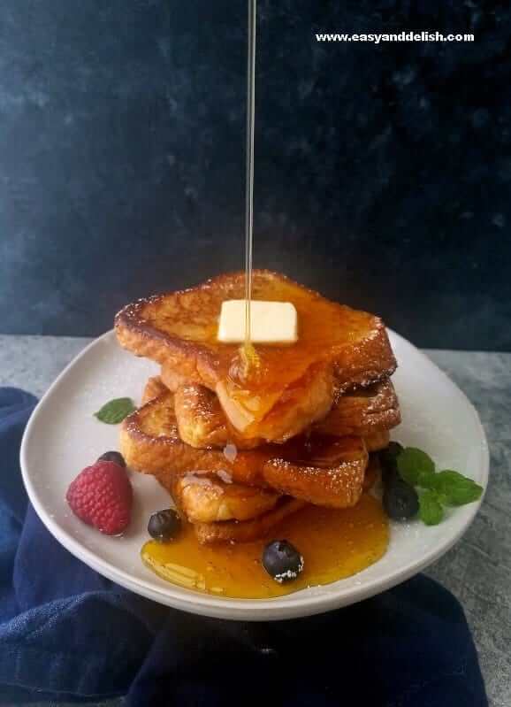 Honey and butter served over a stack of French toast