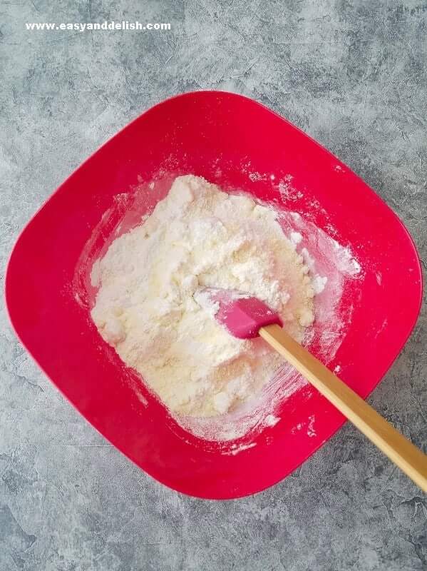 mixing ingredients from Brazilian cheese bread in a bowl