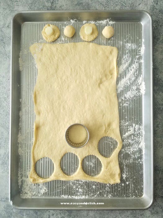 cutting roll dough for garlic bread rolls