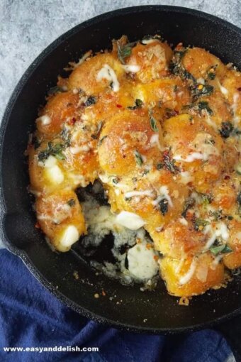 close up of garlic bread rolls in a skillet