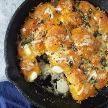 close up of garlic bread rolls in a skillet