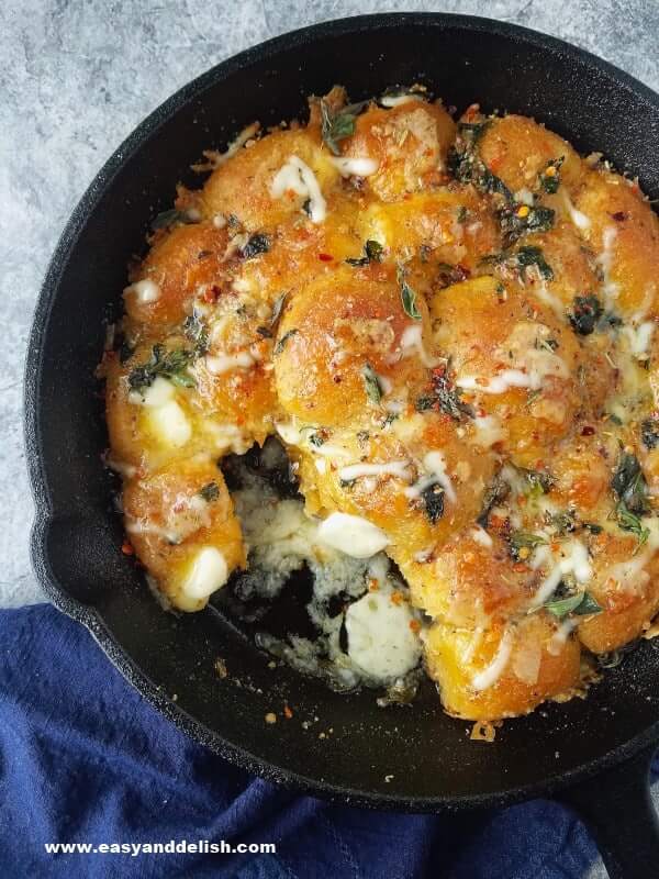 close up of garlic bread rolls in a skillet