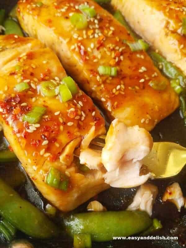 sriracha teriyaki salmon being eaten with a fork