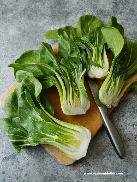 halved bok choi on a cutting board