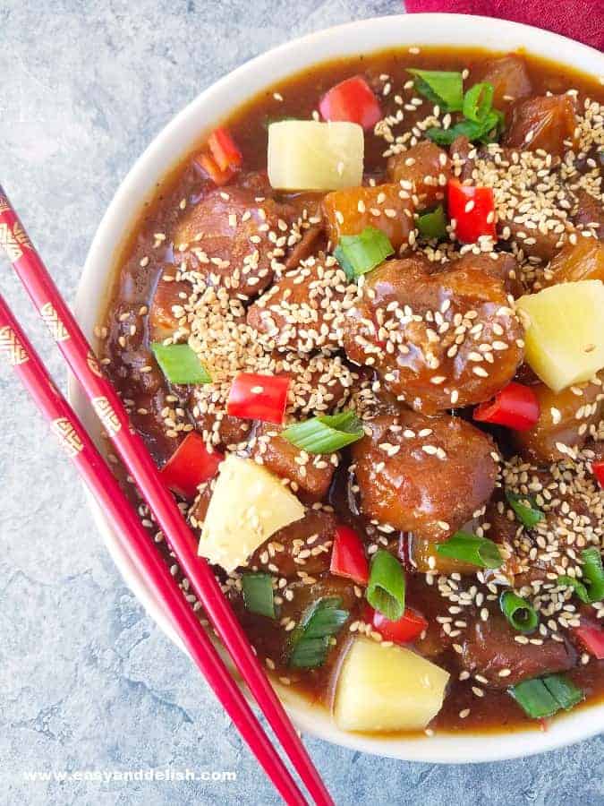 close up image of sweet and sour pork in a bowl