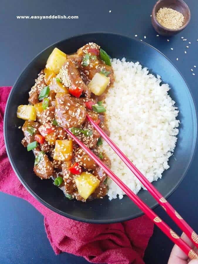 sweet and sour pork with rice in a bowl