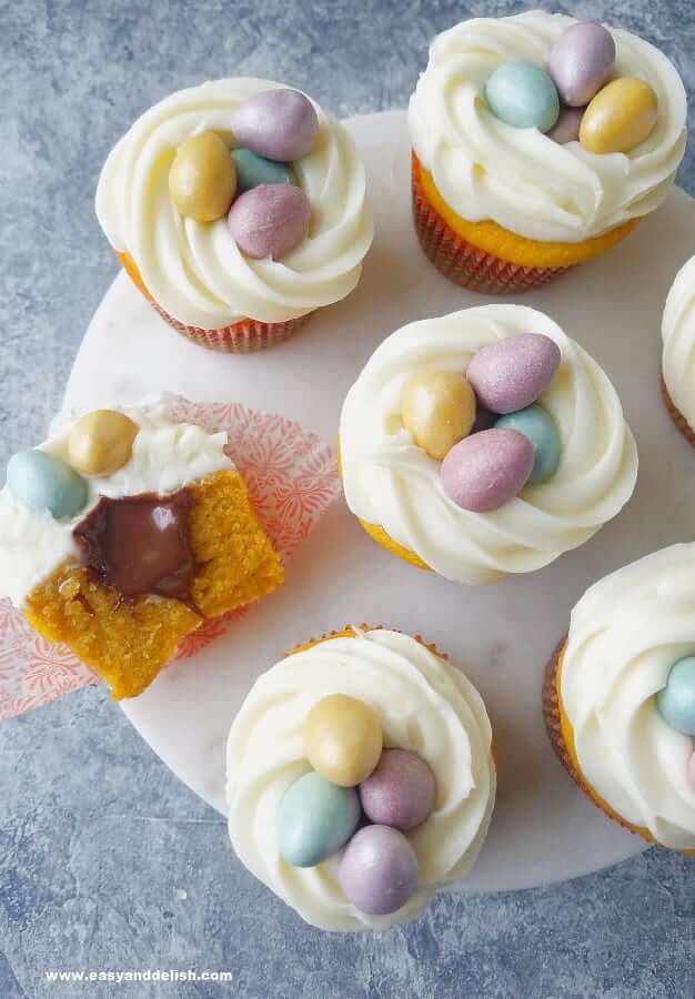 carrot cupcakes in a platter with one halved