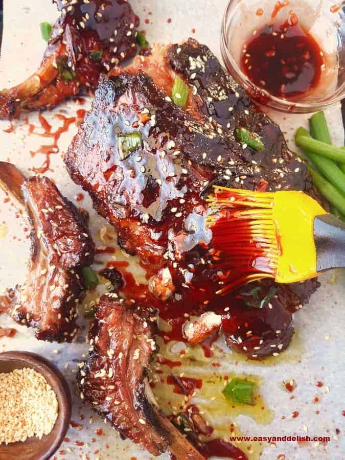 Chinese barbecue ribs being brushed with sauce