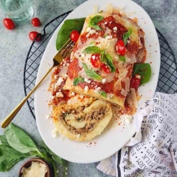 potato roulade sliced in a platter over a rach with a fork on the side