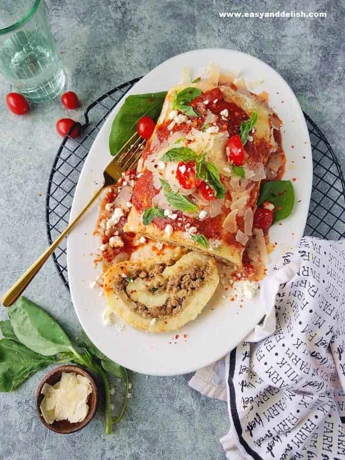 potato roulade sliced in a platter over a rach with a fork on the side