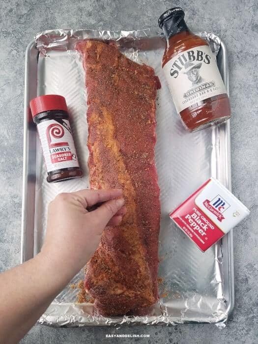 rubbing seasonings on meat stack