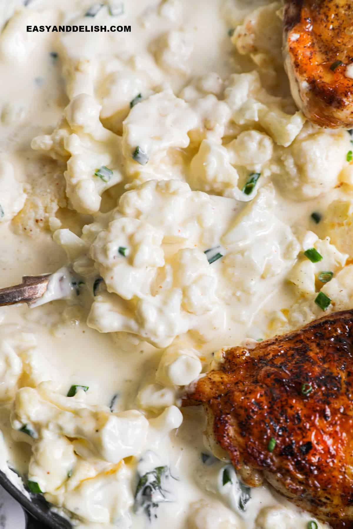 close up of keto cauliflower mac and cheese and its creamy sauce