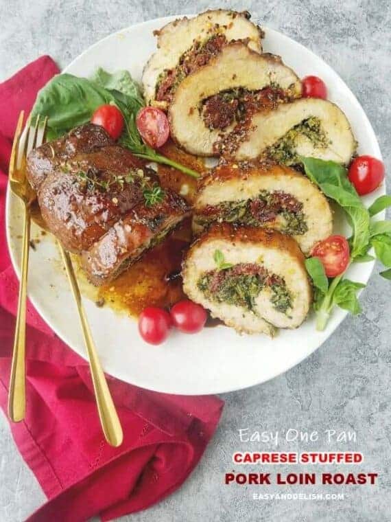 A plate with partially sliced stuffed pork loin roast.