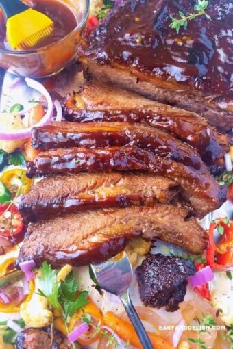 A close up of beef brisket with veggies