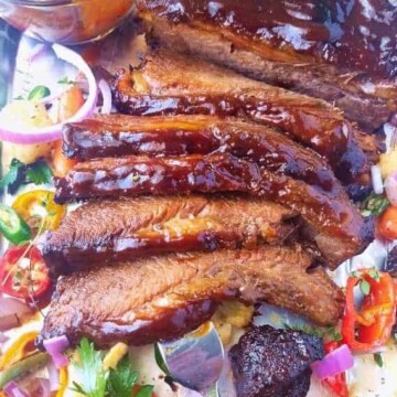 A close up of beef brisket with veggies