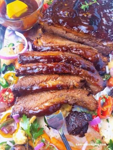 A close up of beef brisket with veggies