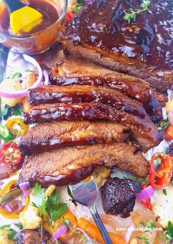 A close up of beef brisket with veggies