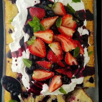 berry cake topped with fresh berries