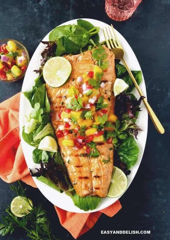 cooked salmon fillet served in a platter with salsa bowl on the side