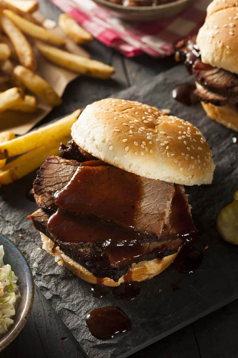 brisket sandwich with bbq sauce and French fries