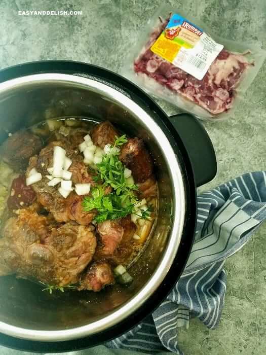 browned oxtail meat in the pressure cooker