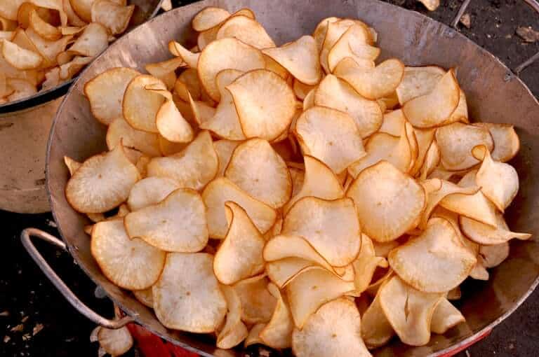 Deep fried cassava chips in a pan
