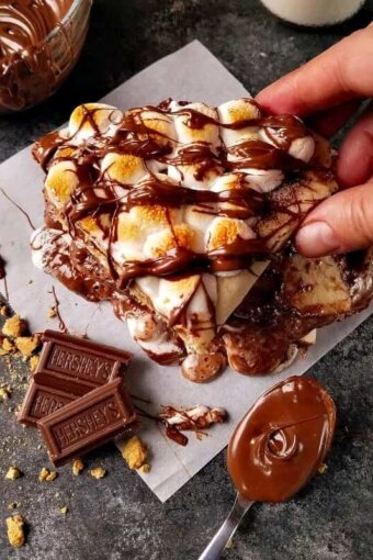 A pile of smores quesadillas being picked