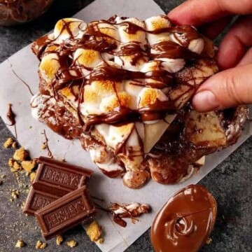 a pile of smores quesadillas being picked