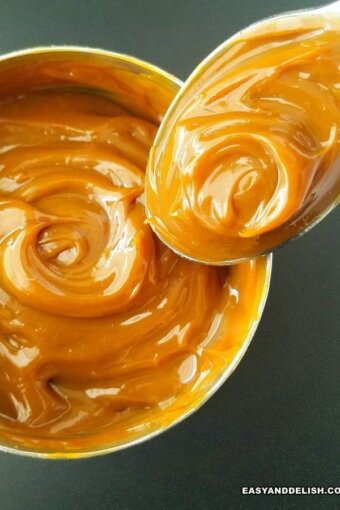 a can of homemade dulce de leche with a spoon