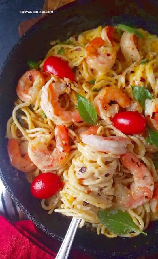 rolling pasta and shrimp scampi with a fork