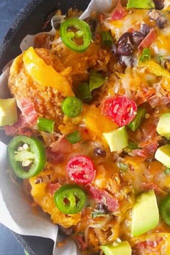 A close up of loaded chicken nachos