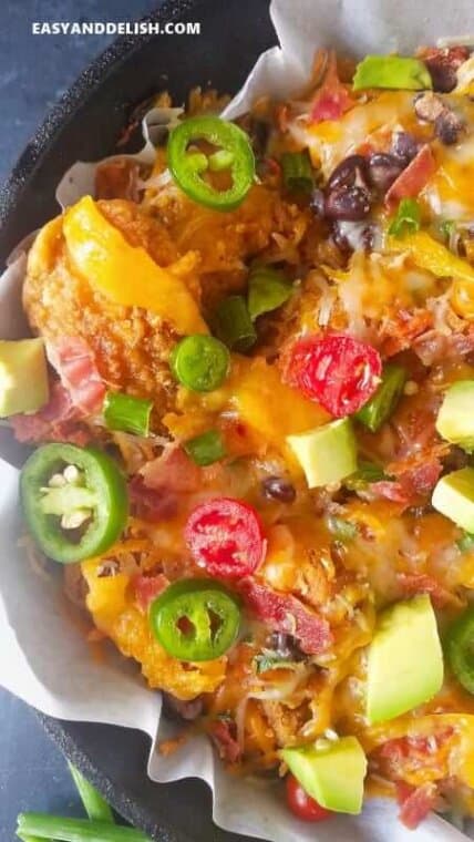 close up of loaded chicken nachos in a skillet