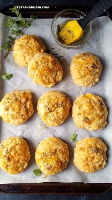 low carb biscuits onto a baking sheet with herby butetr on the side 