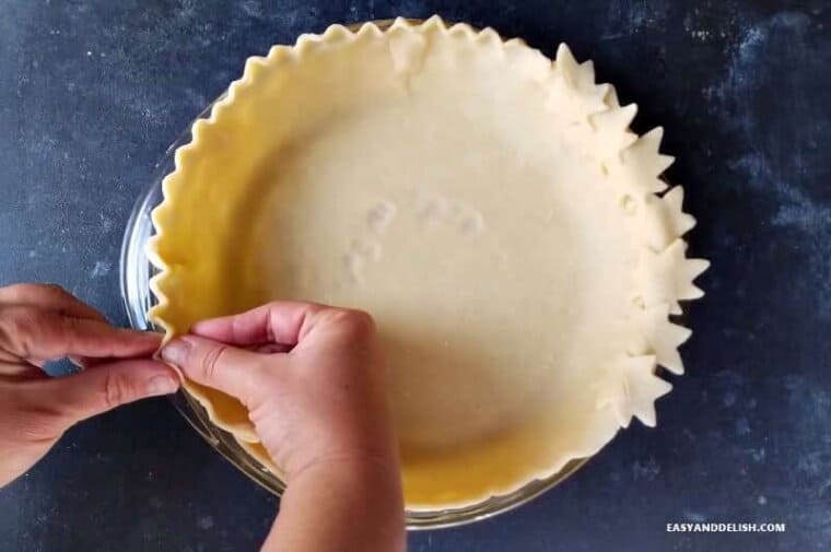 pie crust for pecan pie being crimped 