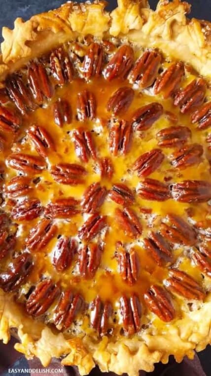 close up image of beautifully decorated and baked Texas pecan pie