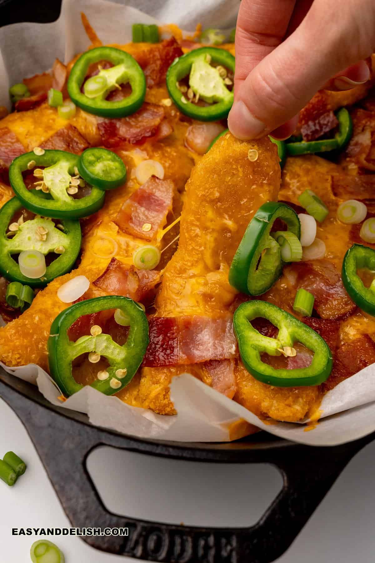 keto nachos held by a hand