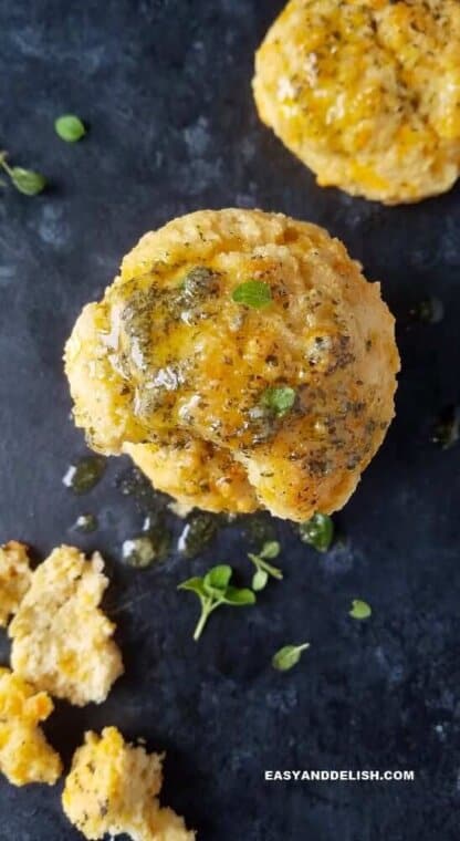 Copycat Red Lobster Keto biscuits over a table served whole and also with crumbs on the side