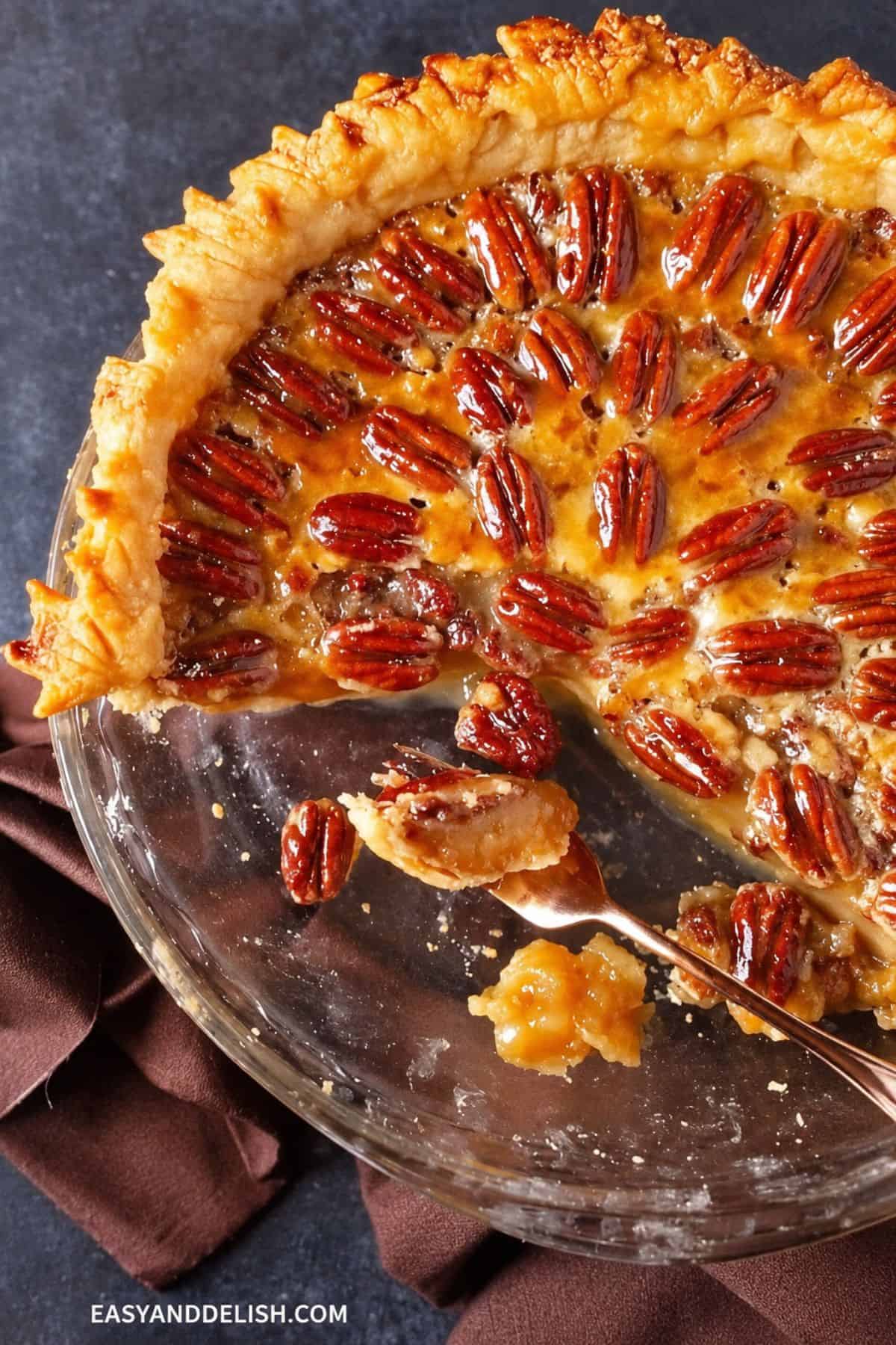 Baked Texas pie with a slice removed and a serving spoon in front.