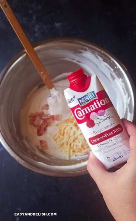pouring carnation milk into a bowl