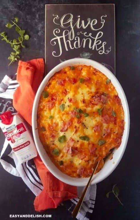 broccoli au gratin in a baking dish with "Give Thanks" sign on the back